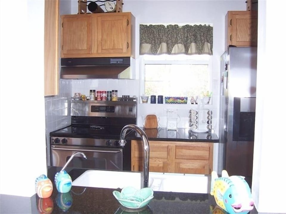 A peek in the kitchen fm the LR; all stainless st appls and granite counter tops