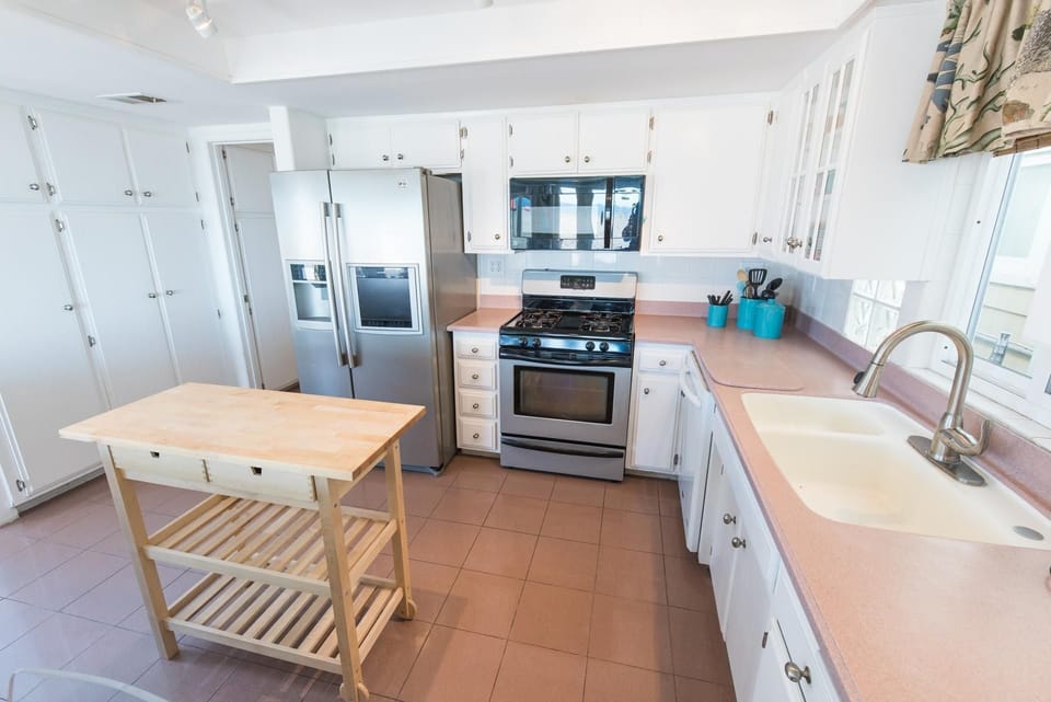 The kitchen comes stocked with a basic supply of dishes, utensils, cookware, bakeware, and all large and small appliances.
                