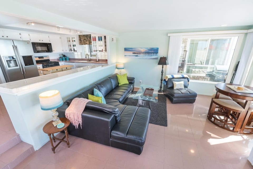 The kitchen overlooks the main living area, patio, and beach beyond. While we can ensure the cleanliness and functionality of the property, the general condition and furnishings of this unit would be considered "basic" or "below average."
                