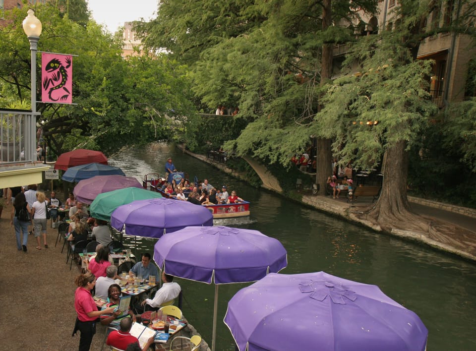 The riverwalk is lined with restaurants and shops.