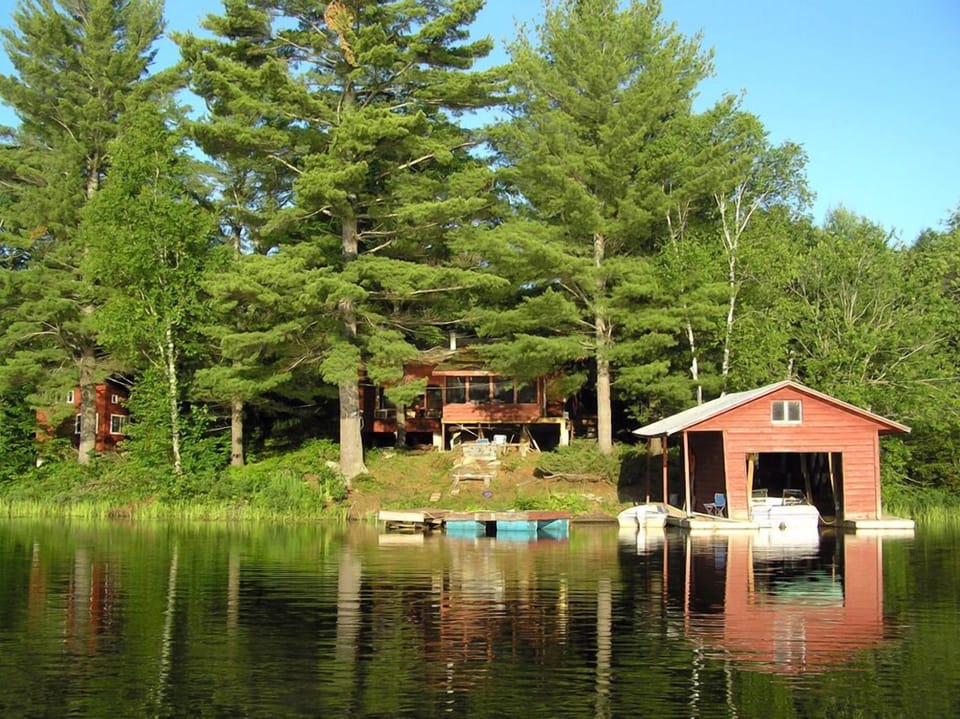 This shows the cottage (center), bunkie (left), and boathouse, in the morning.
