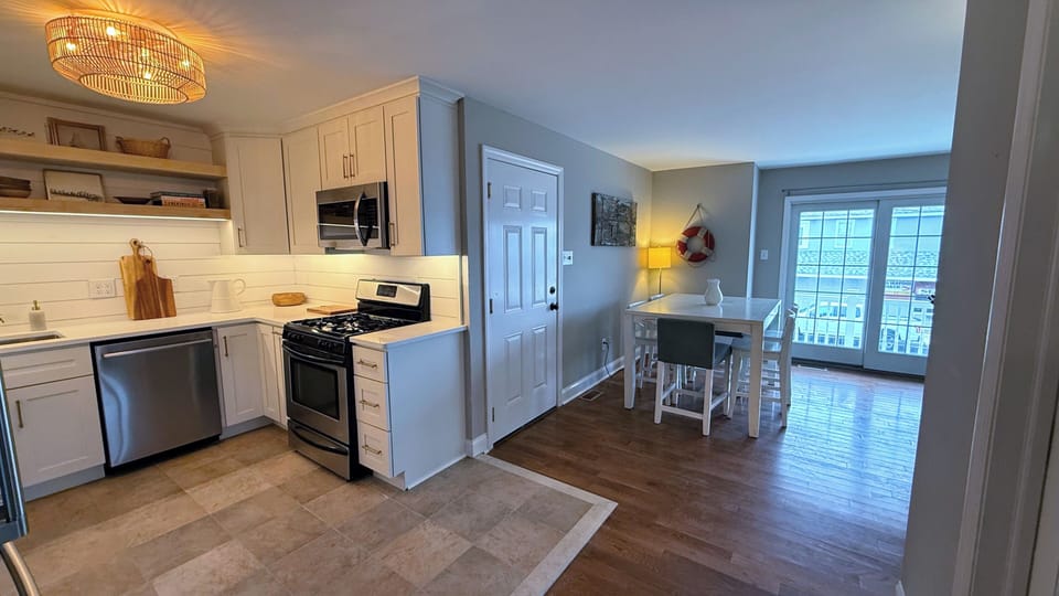 Kitchen and dining area with sliding door access to balcony