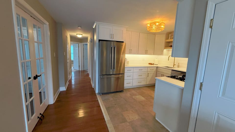 Kitchen and hallway leading to bedrooms. French doors open to the 3rd bedroom.