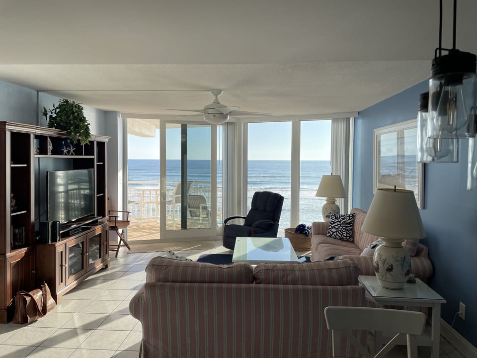 Great room w/ smart TV, Wifi, cable, balcony w/4 high top chairs, glider, table.