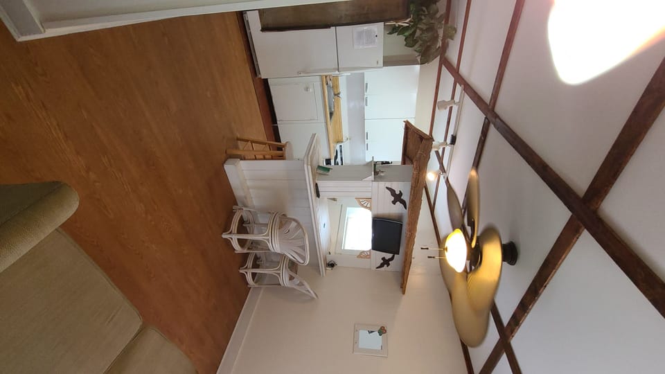 Panoramic view of living room and kitchen from hallway