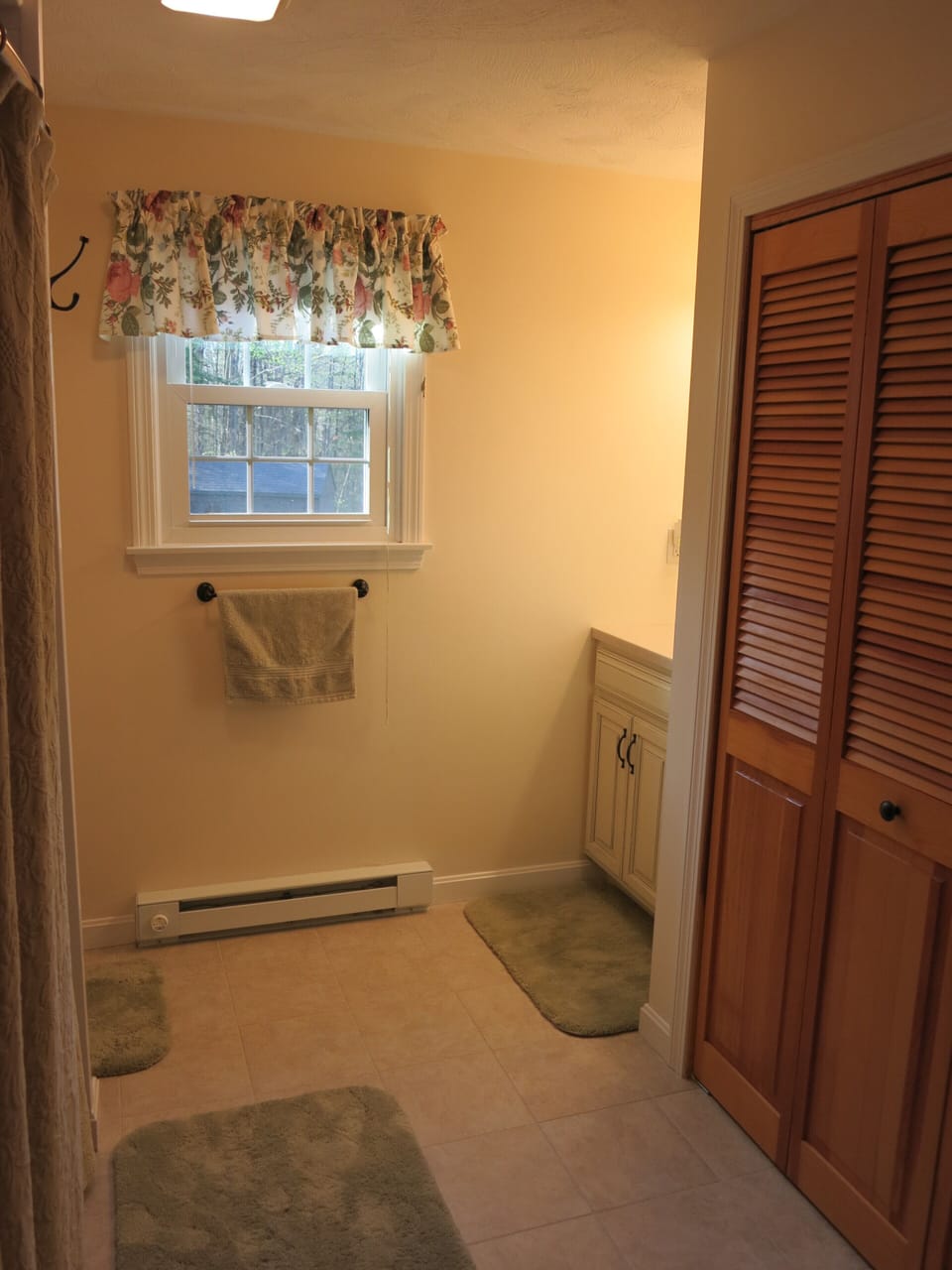 First floor bathroom with shower and tub across from master bedroom. 
