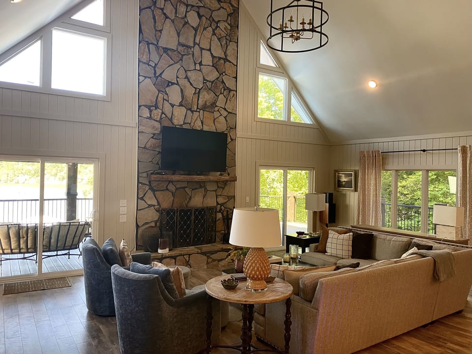 Greatroom with sectional sofa, club chairs, fireplace and 65" TV