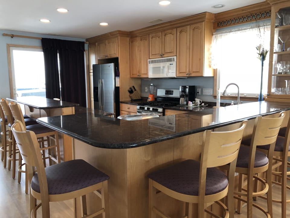 kitchen has easy access to back deck with hot tub and Weber barbeque