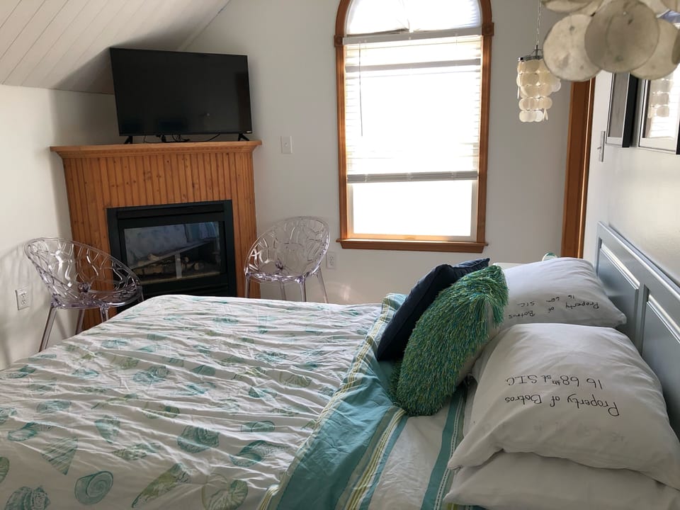 Front master bedroom has TV, fireplace, and ceiling fan