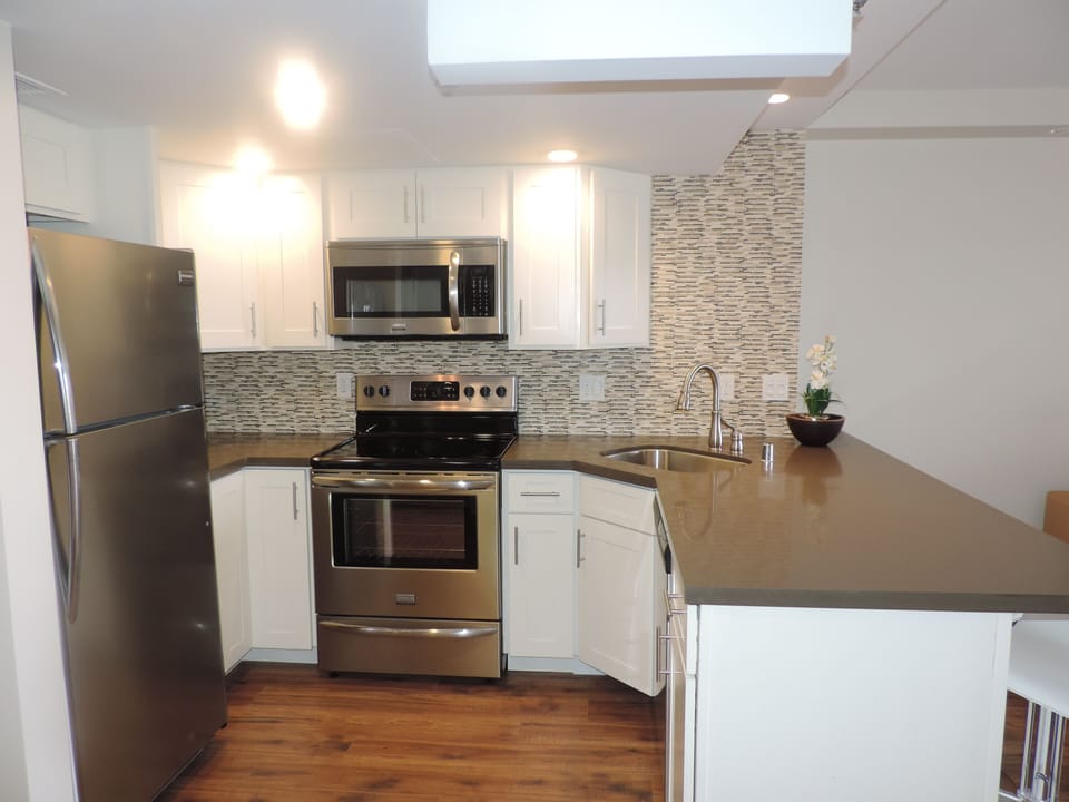 Fully equipped, sleek modern kitchen with all stainless steel appliances