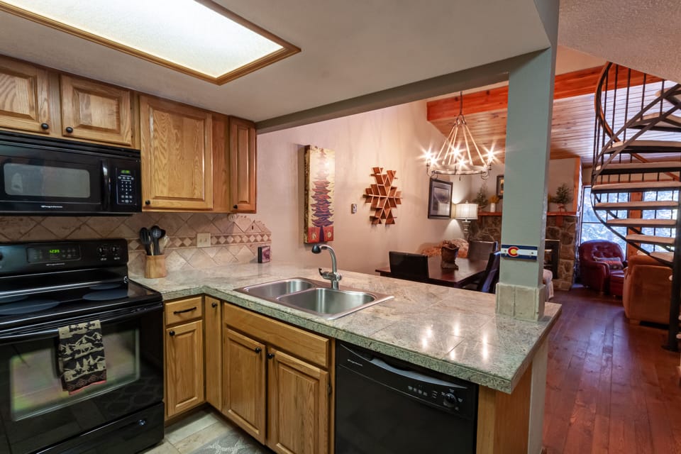 Well-stocked kitchen with bar seating for 3 people.