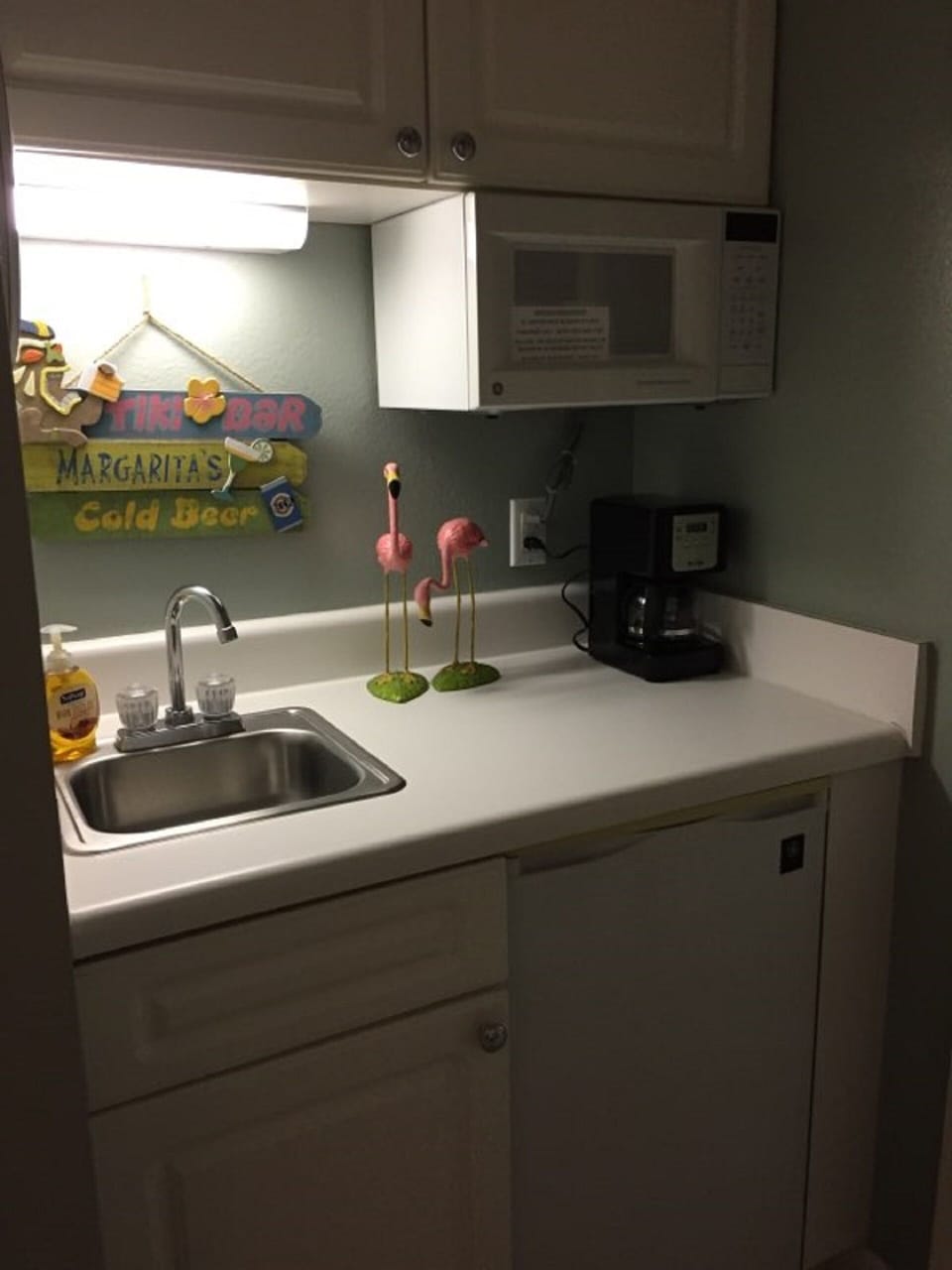 Lock out suite has small kitchen with microwave, sink and refrigerator...