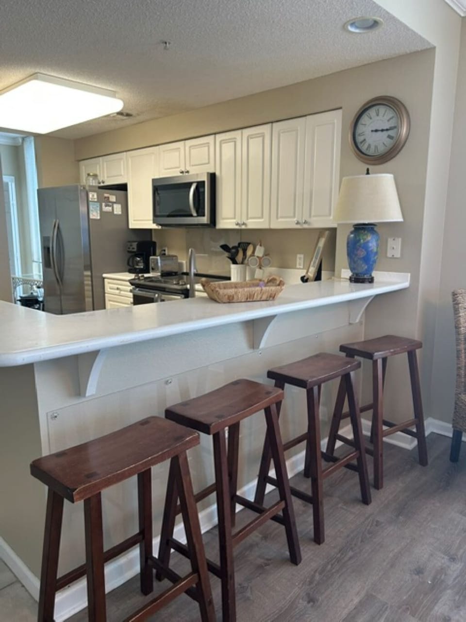 kitchen - behing frig - seating area and full size  washer/dryer