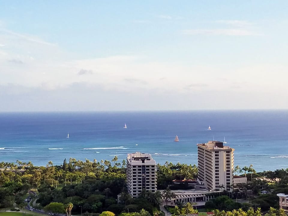 view of sail boats off Waikiki beach from window