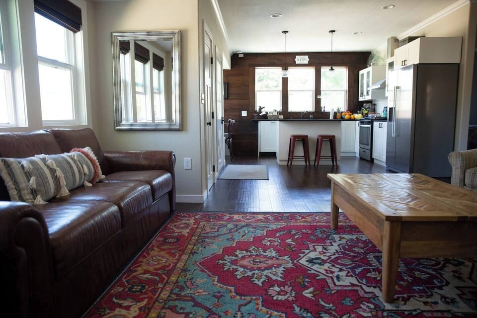 The family room is open to the kitchen and has a couch, club chairs, and a TV (no cable). 