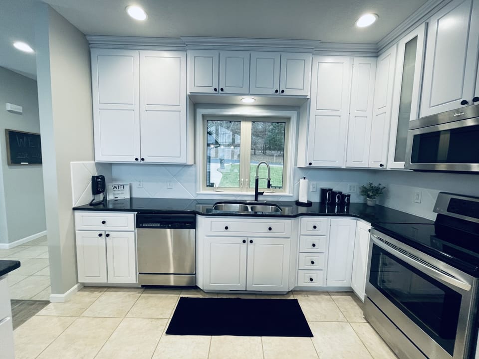 Kitchen-standard coffee maker, toaster, crockpots, utensils, & large fridge.