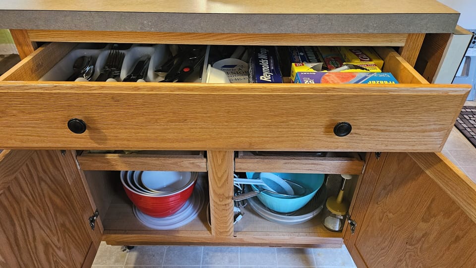 Kitchen storage in the Island; more storage next to and above the oven & counter