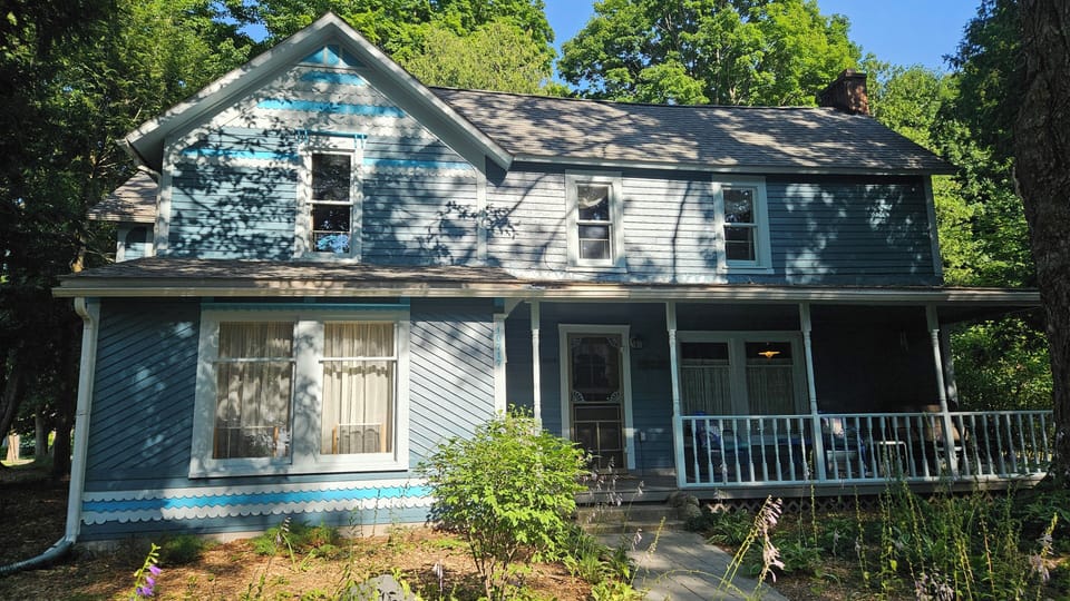 Sunlight and trees' shadows on front of home, looking from Terrace Street