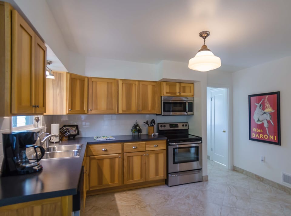 Entirely new kitchen, and a 1/2 bath near the back door and lower level stairs.