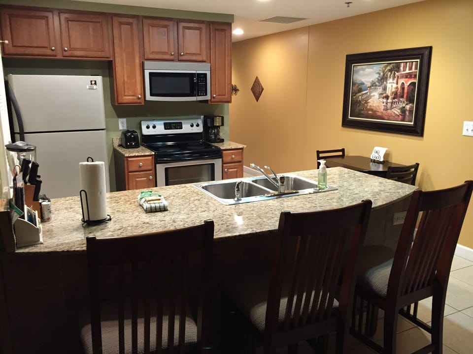 Kitchen with granite countertops and breakfast bar -new fridge & paint now!