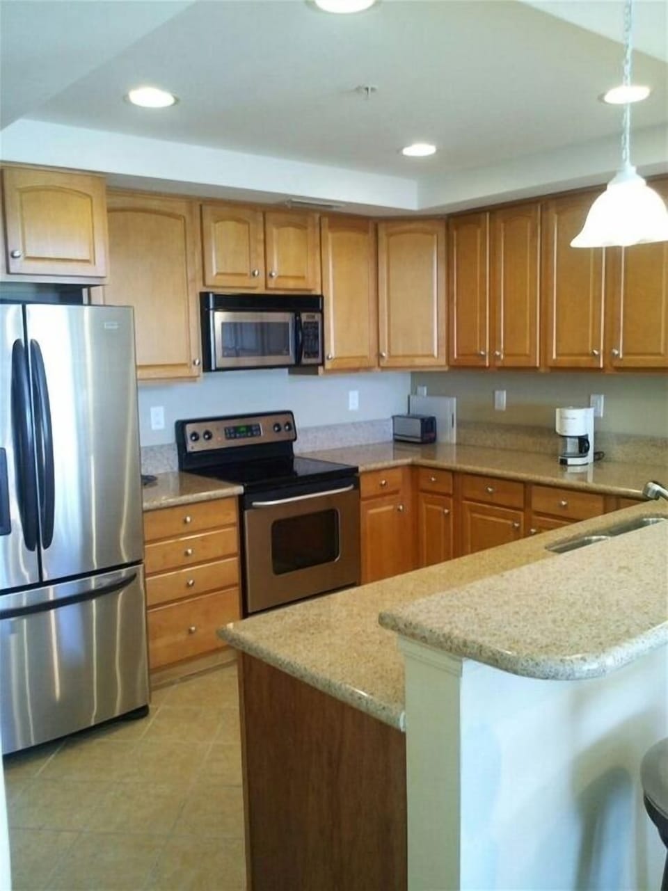 Kitchen with granite countertops and stainless steel appliances.