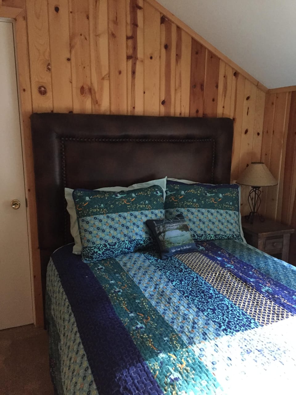 Upstairs guest room with Queen bed at front of cabin