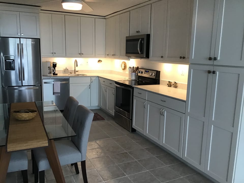 Fridge with icemaker, microwave, range, Keurig and regular coffeemakers.