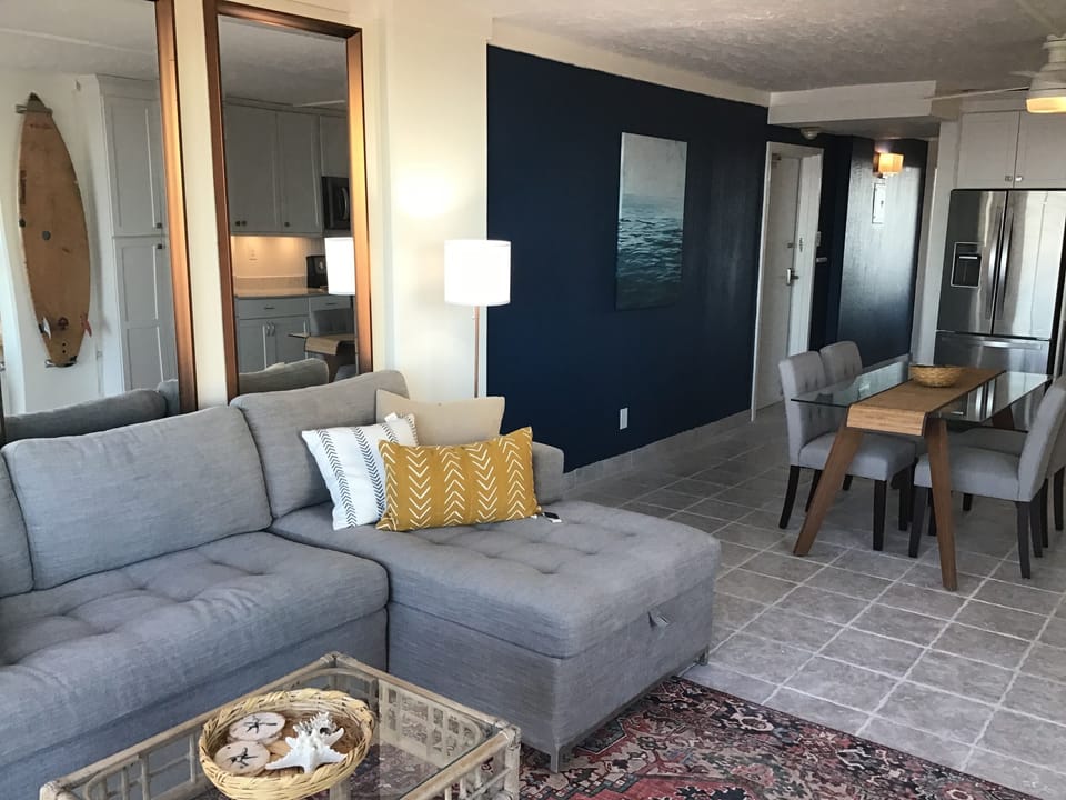 Calm grey couch with a punch of yellow