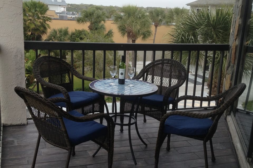 Spacious Balcony with seating and lounger.