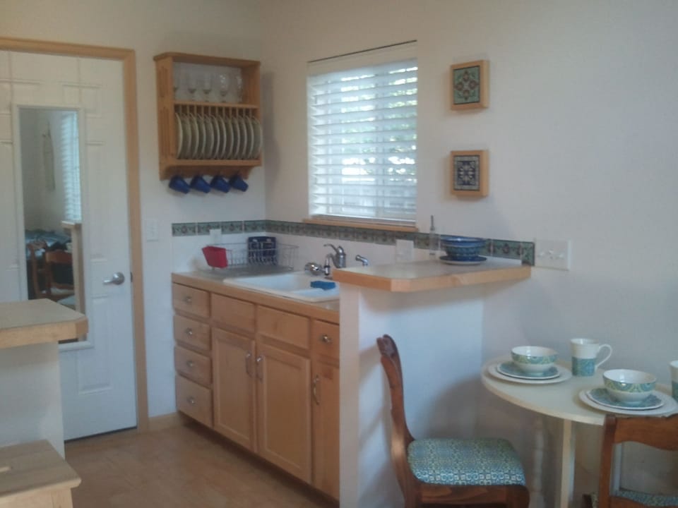 Quaint, cottage kitchen with hand-painted tiles.