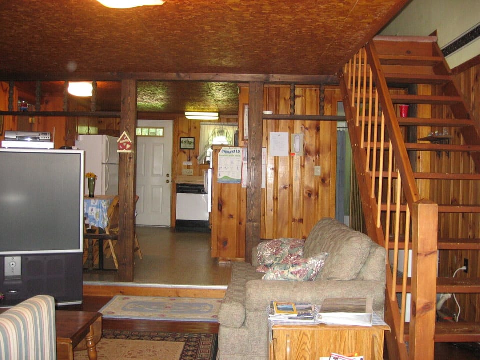 Living room and kitchen from the deck door, stairs lead to master bedroom