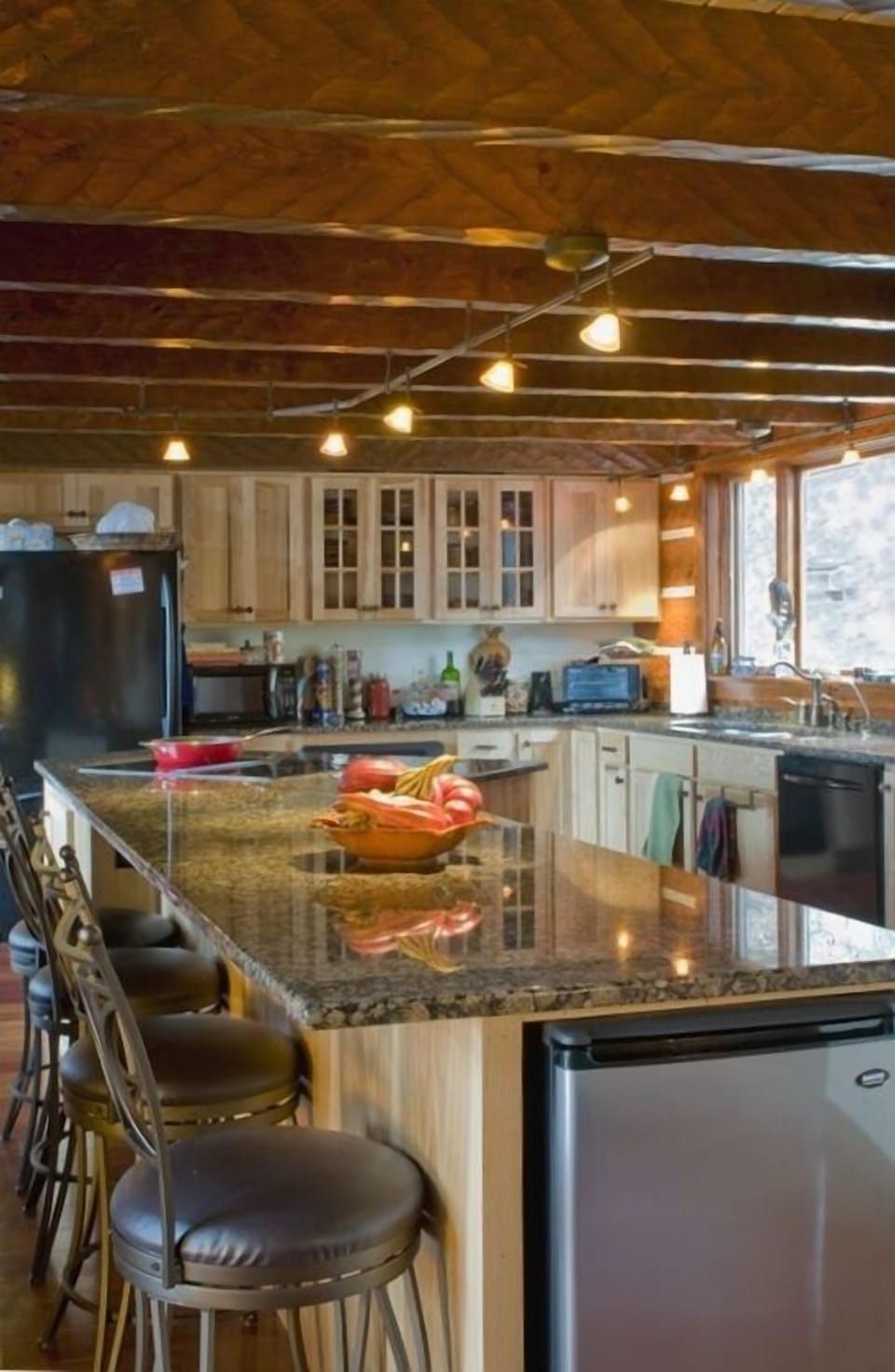 Modern, equipped, gourmet kitchen with extra long island for team cooking.