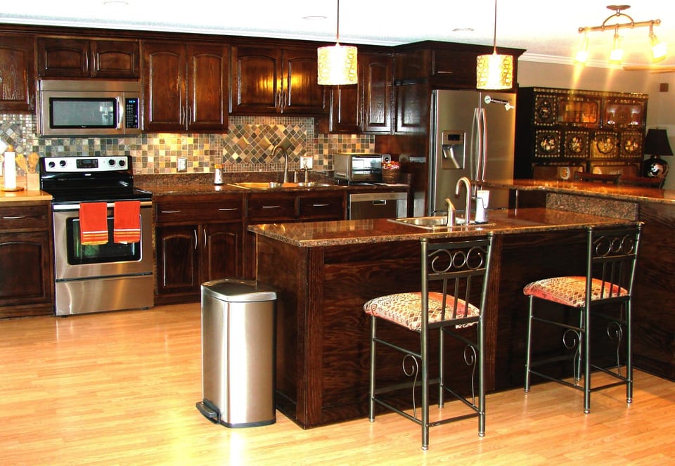 Main kitchen with custom made cabinetry, and granite/butcher block countertops