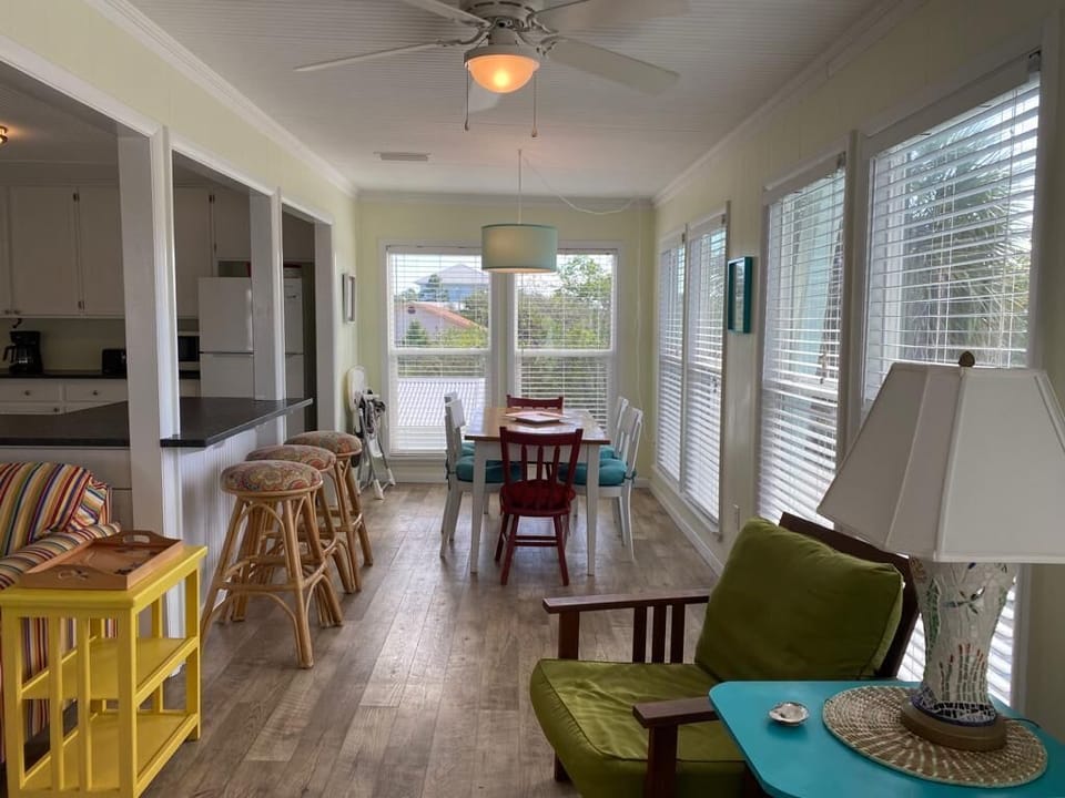Sunny dining table comfortably seats six, three bar stools and a high chair.