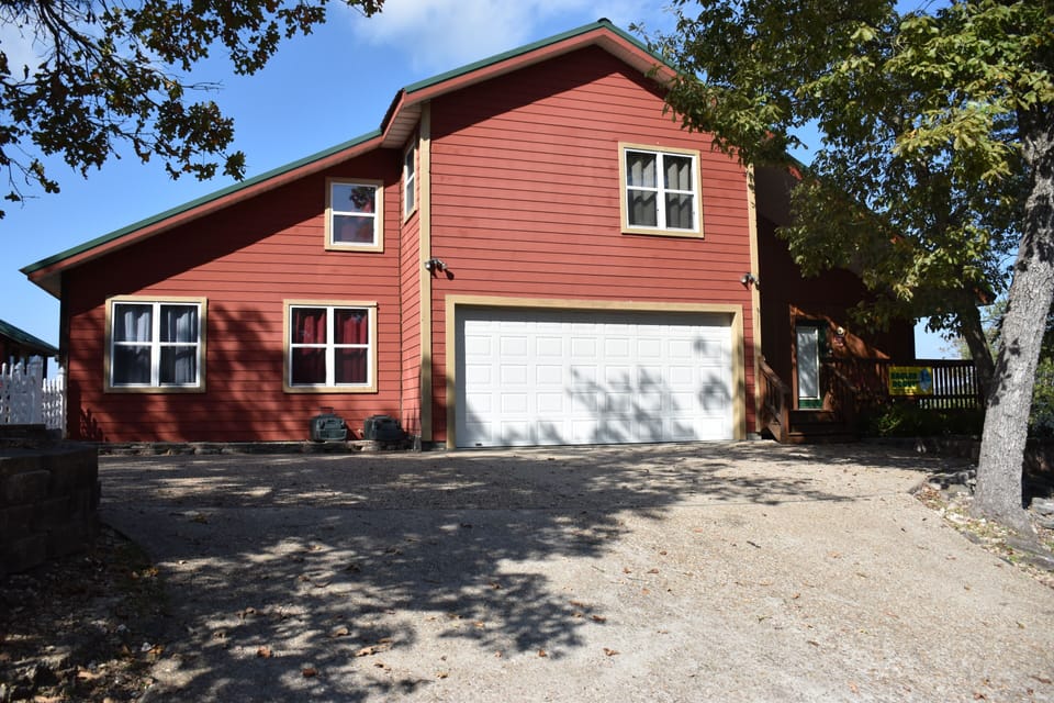 Home front with concrete parking and indoor garage