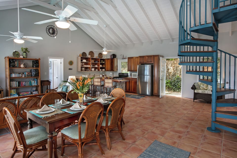 Dining area and view of back entry-spiral staircase leads to upper level bedroom