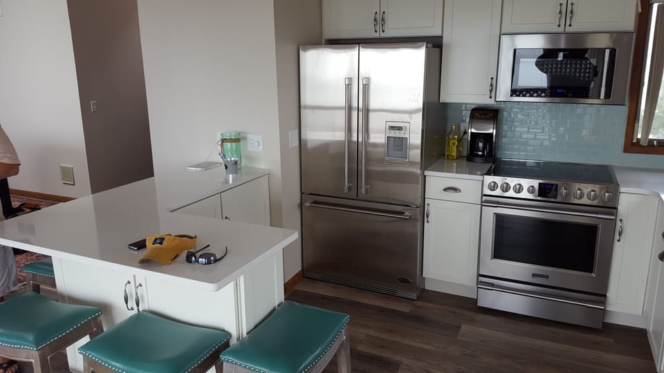 Modern stainless Steel Kitchen with Bay views and Beach glass backsplash