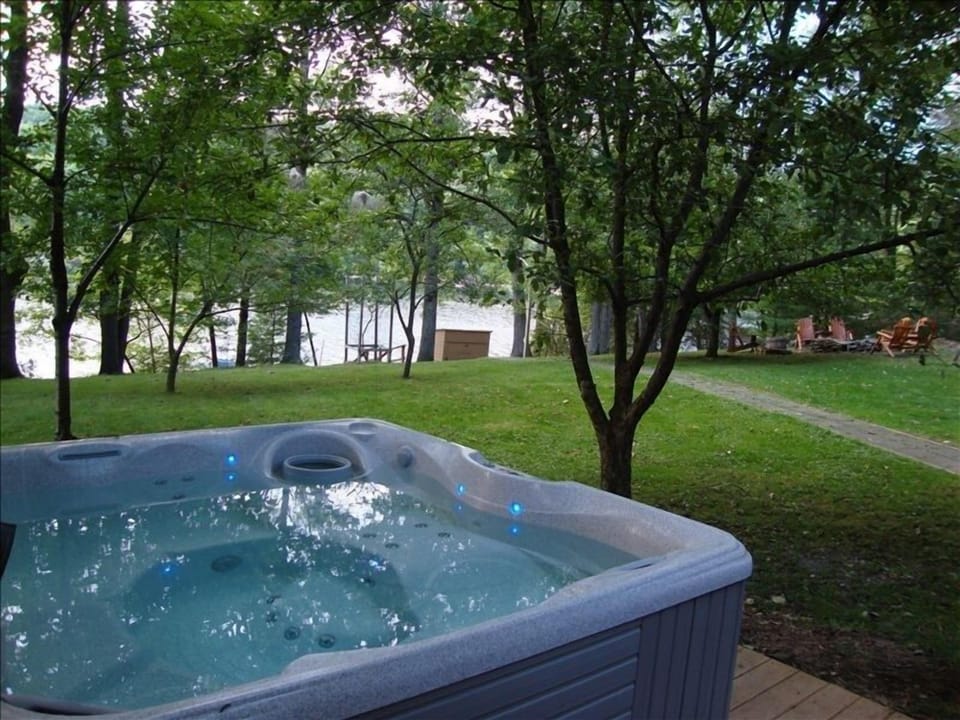 View of hot tub and lake