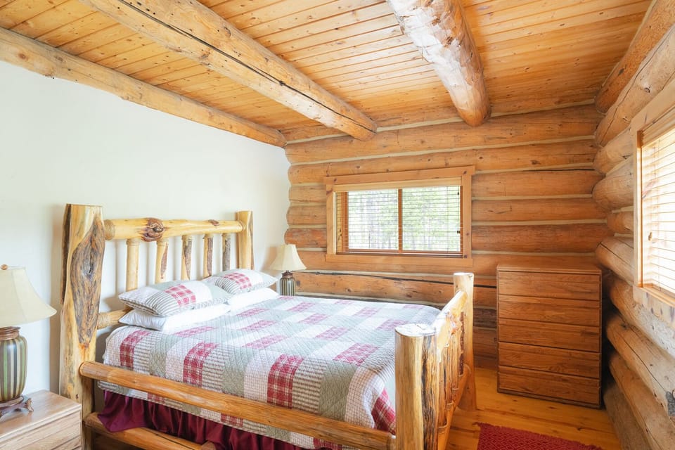 Queen-sized log bed in 2nd bedroom on the main level. 