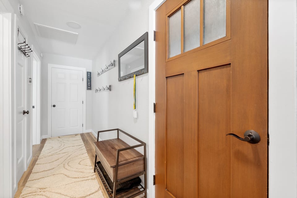Entry with bench and tons of hooks for storage of ski/snowboard gear