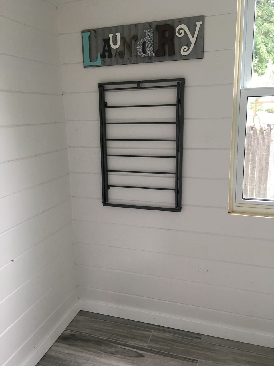 Laundry room includes washer & dryer, Iron & Ironing Board, and a drying rack.