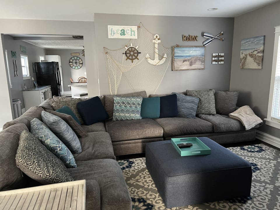 Family Room with Large Sectional couch and a 55” TV.