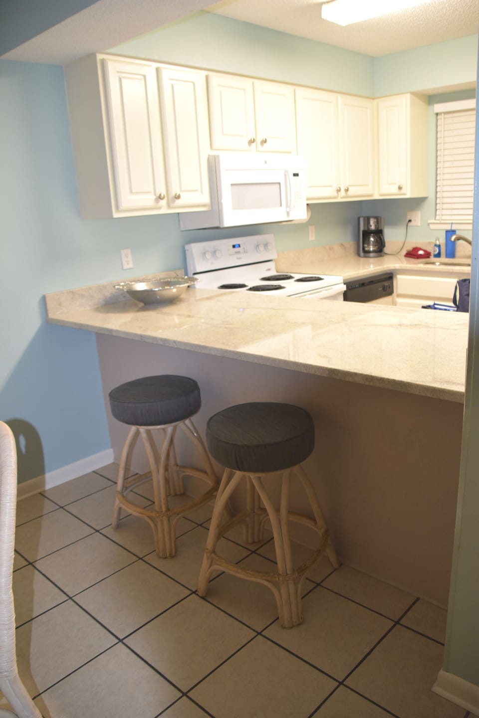 Kitchen area with bar stools for two.