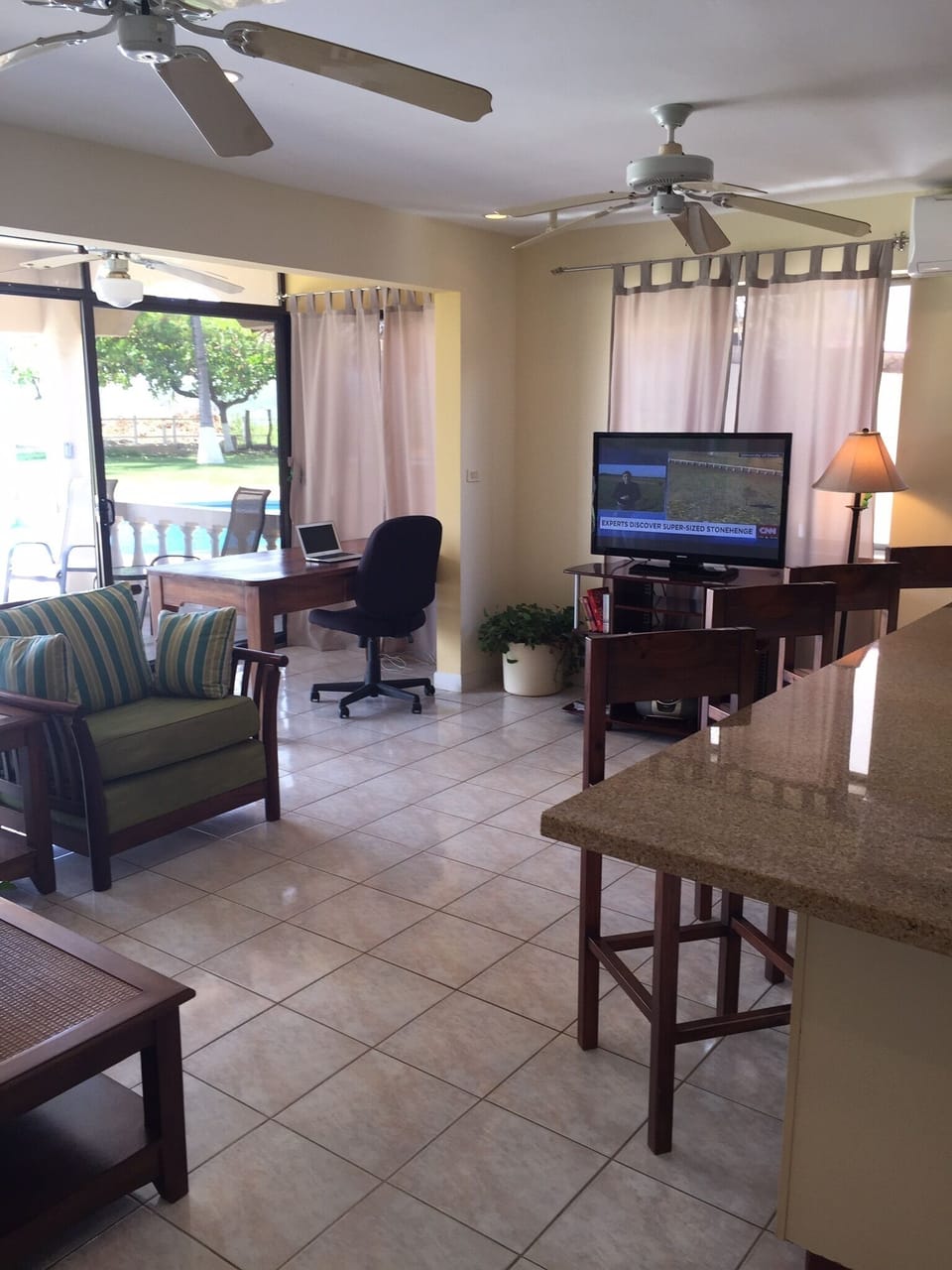 Living room with 40 inch flat screen tv and work desk sofa and to big Chairs 