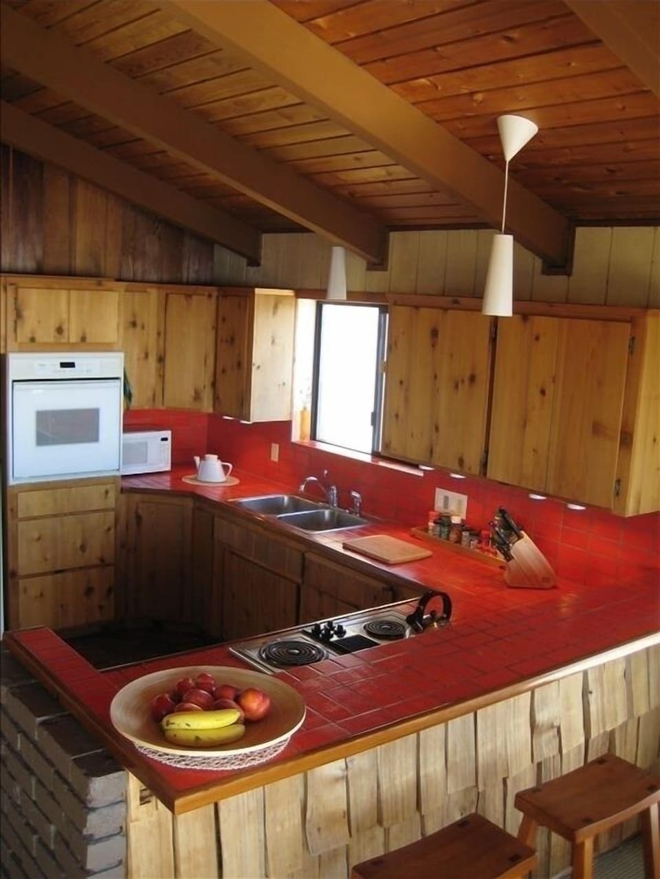Full kitchen with all your cookware, dishware needs and fiery red Italian tile!