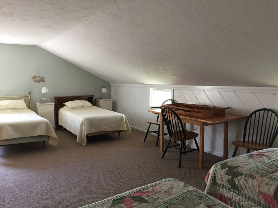 Bedroom with four single beds on the wooded side of the house