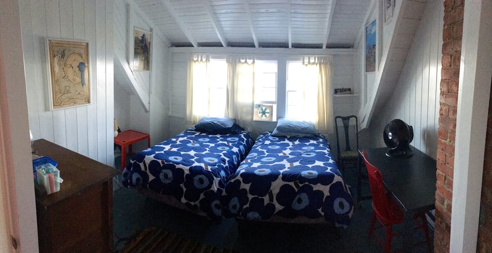 Upstairs twin bedroom.Water views. Perfect desk to write. Vintage fair posters.