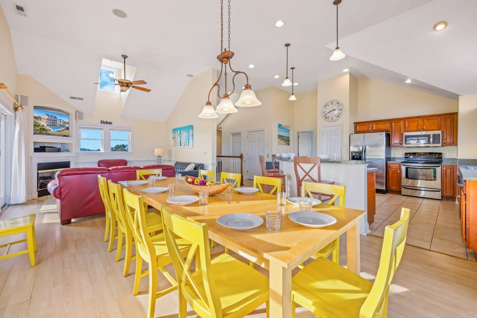 Gather around this bright dining space with cheerful yellow chairs, where you'll create memorable meals together in the open-concept kitchen and living area.
