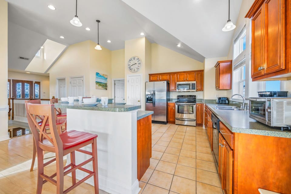 Your spacious kitchen invites culinary adventures with rich wood cabinets, granite counters, and modern appliances perfect for preparing memorable meals.