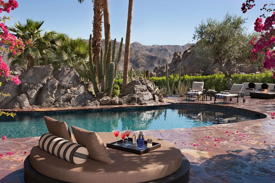 Salt-water oasis pool with ample seating and moveable outdoor umbrellas.